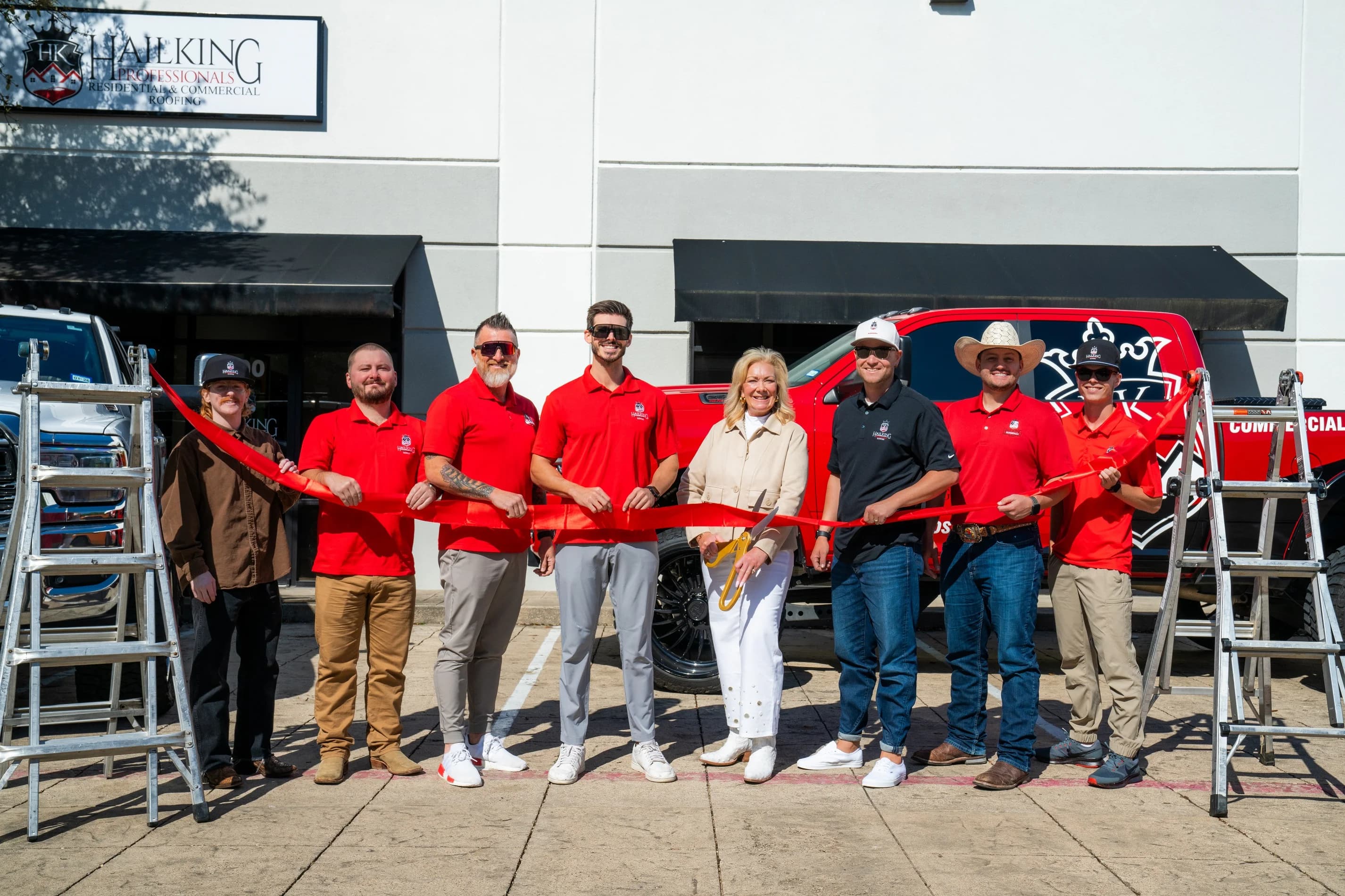 HailKing Professionals team at a ribbon cutting outside the company office