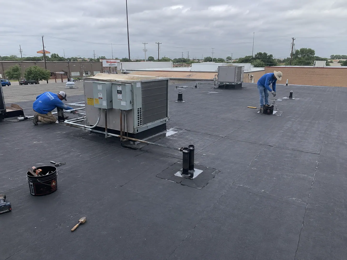 Completed modified bitumen commercial roof around rooftop equipment