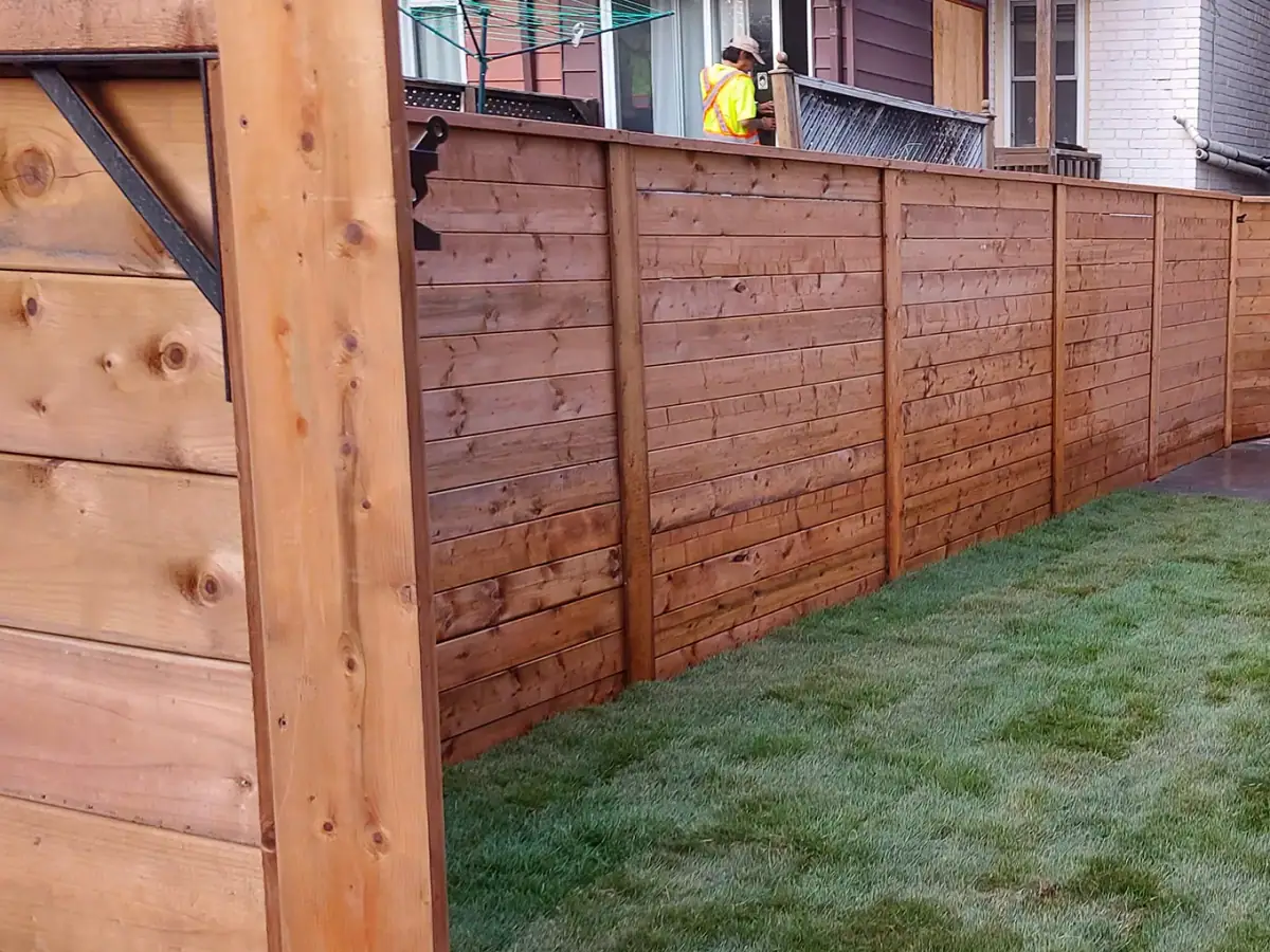 Modern horizontal wood privacy fence with clean post lines