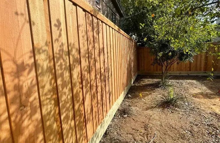 Straight wood fence run following a residential property line