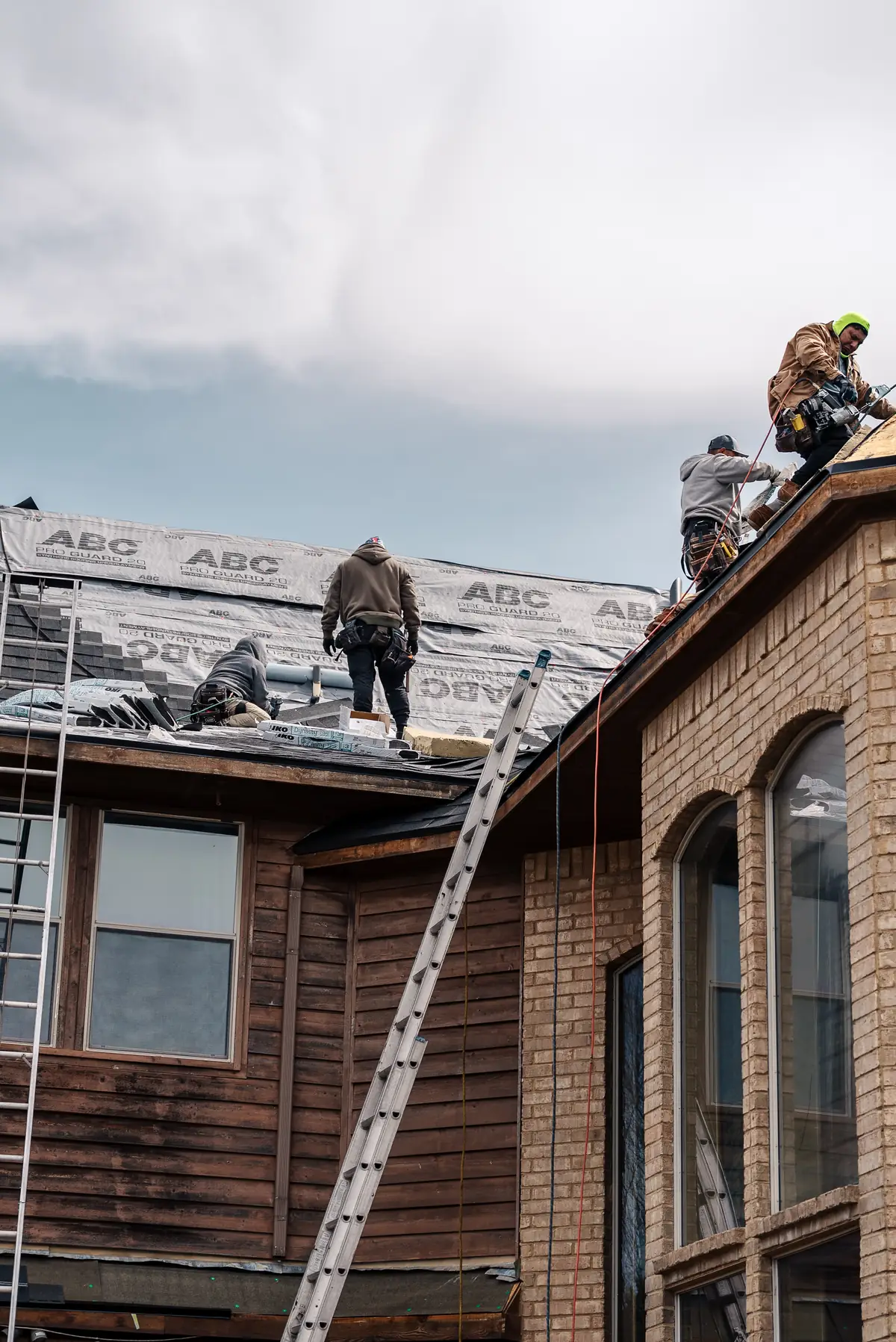 Roofing crew working across a complex North Texas residential roof