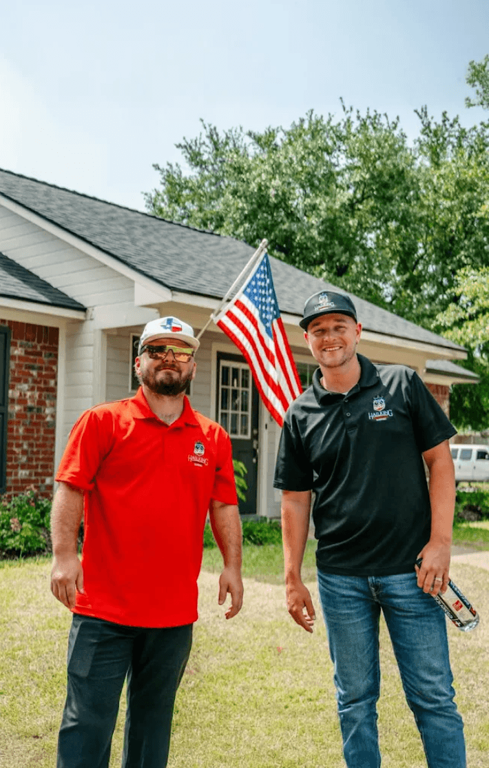 Two HailKing team members standing outside a home