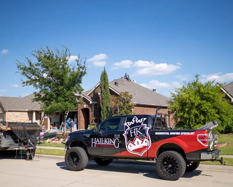 HailKing project vehicles staged near a residential property