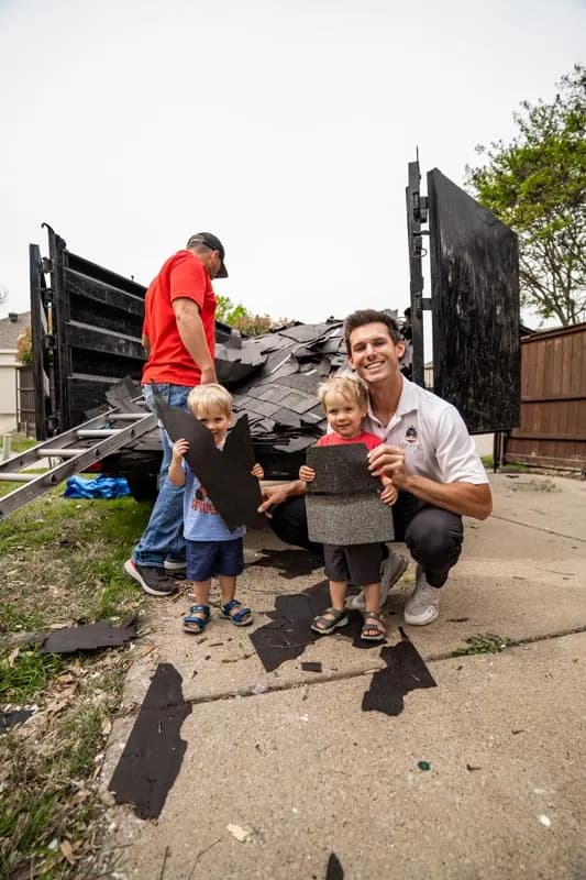 Homeowner and child with a HailKing team member after a project