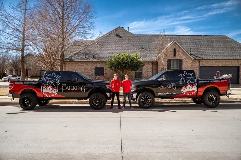 HailKing crews and project vehicles at a residential jobsite
