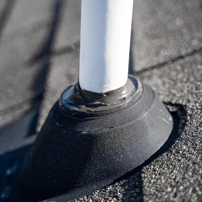 Roof penetration sealed into a completed shingle field