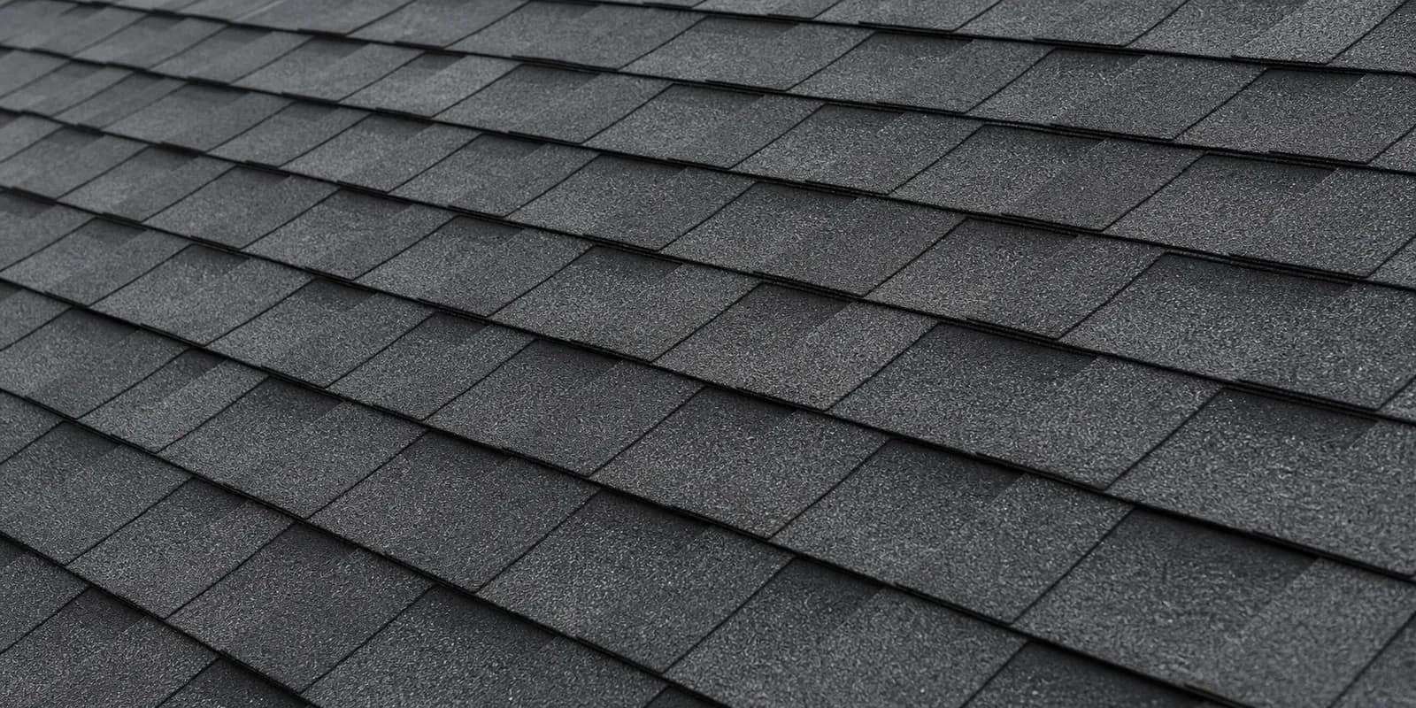 Close view of dimensional charcoal architectural shingles