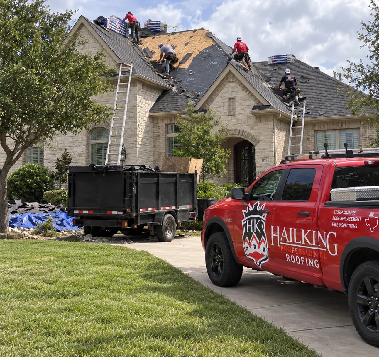 Hail King truck parked beside a home where the crew is installing roofing