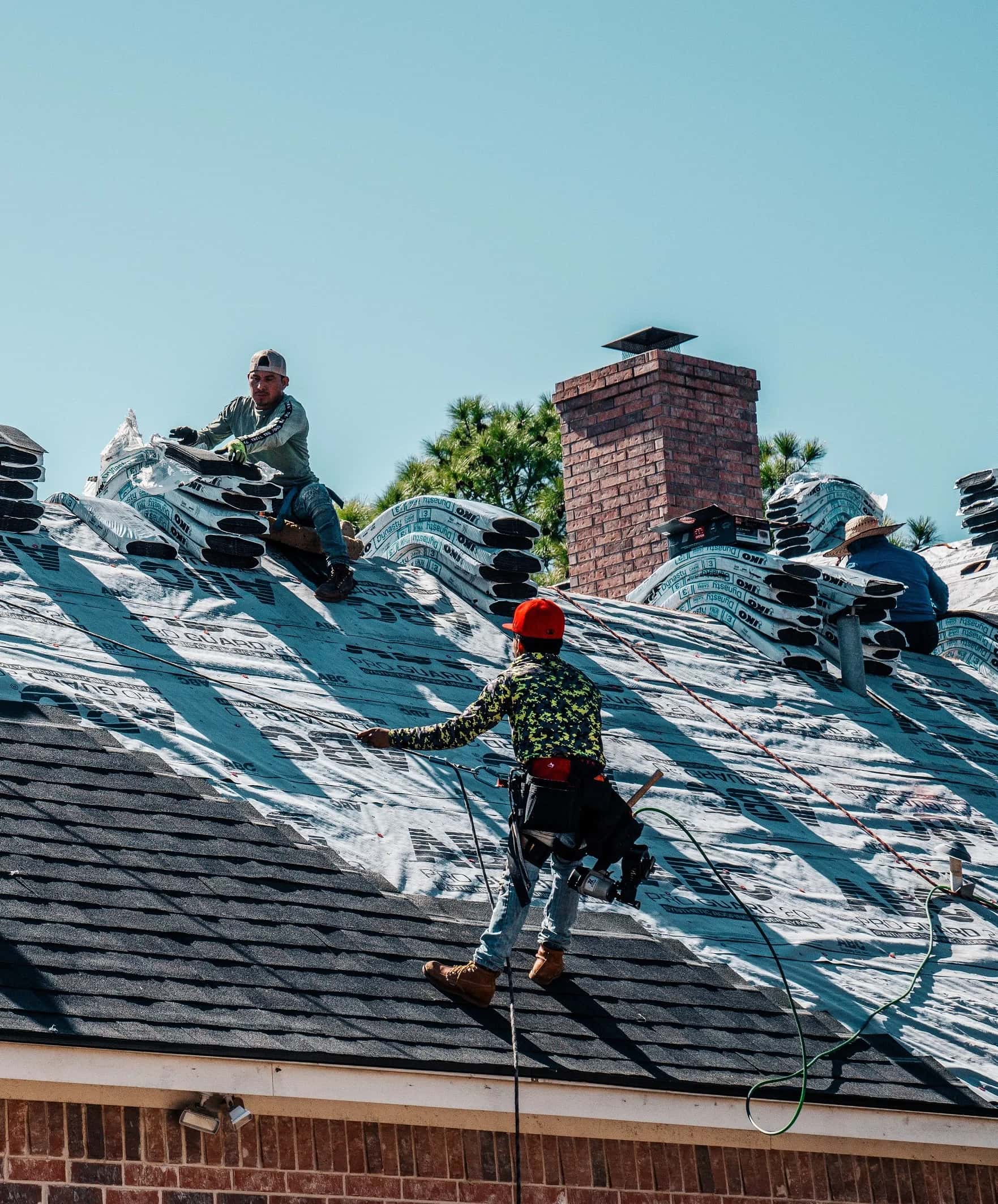 Hail King roofing crew installing a new shingle roof on a North Texas property