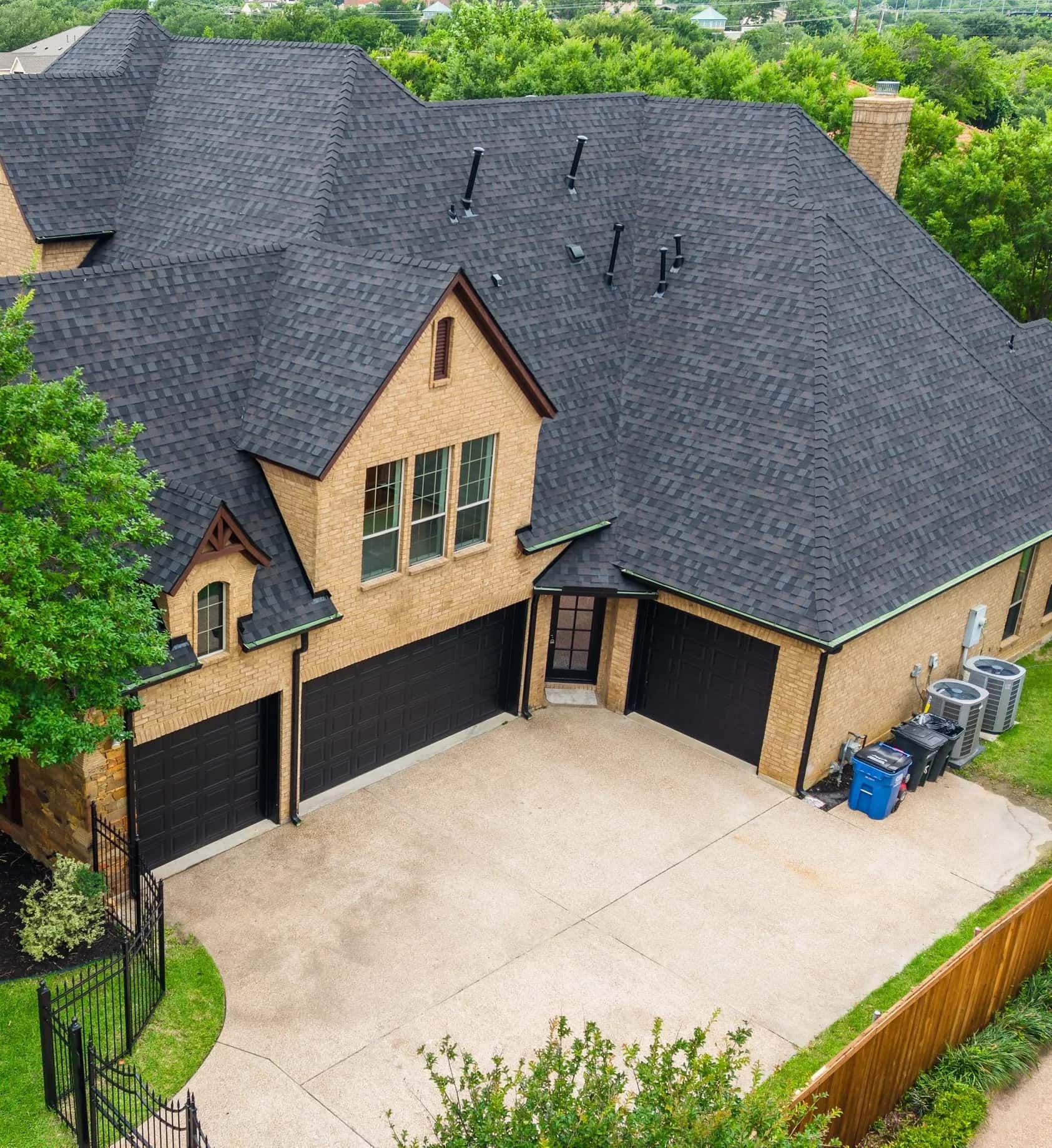 Aerial view of a completed architectural shingle roof on a North Texas residence