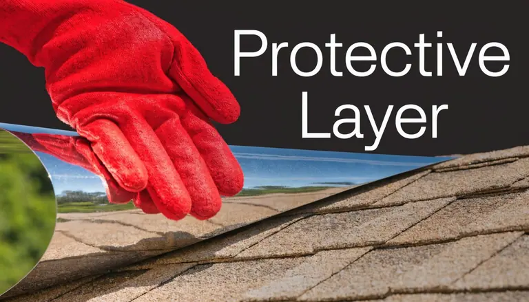 A hand wearing a red glove applying a reflective protective layer over a shingled residential roof.