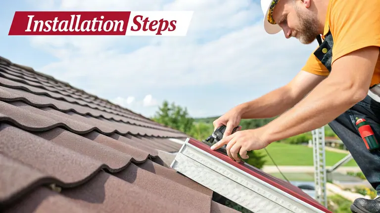 Professional roofer installing new stone-coated metal roof tiles on a sunny day.