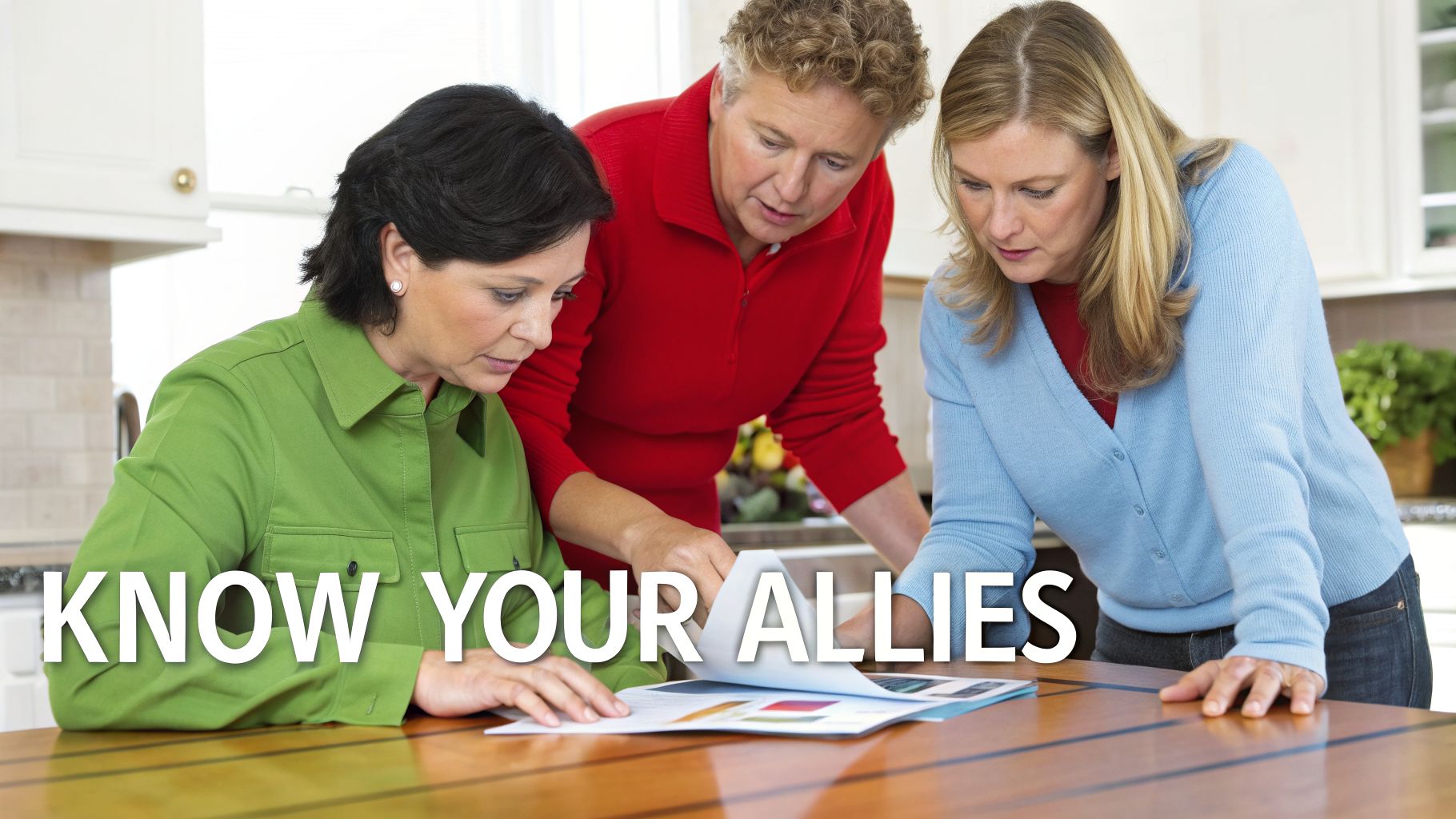 Three women gathered around a table, focused on reviewing documents together in a home.
