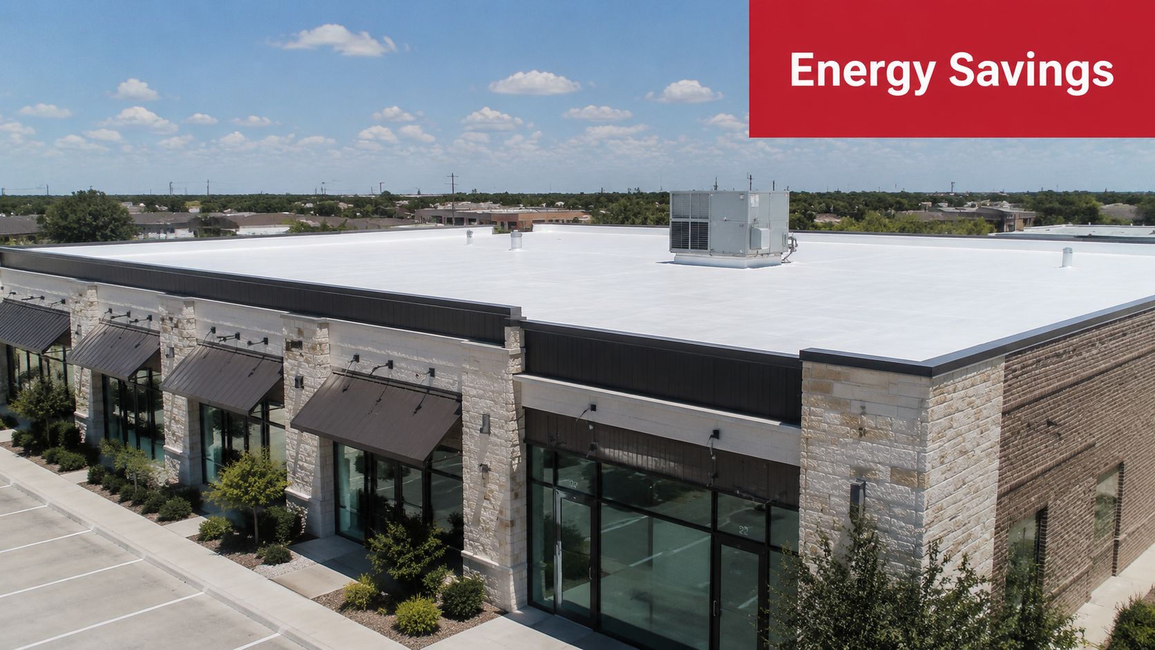 An aerial view of a commercial building with a newly installed white energy efficient roof coating.