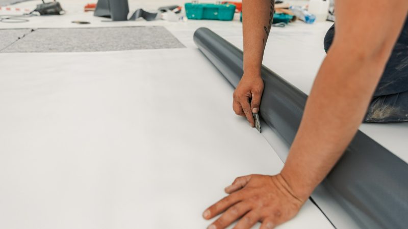 Worker specialized in mounting PVC membranes, TPO in the process of installing a water resistant